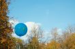 Blue ballon in the autumn sky.