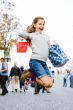 Young girl is jumping on the streets