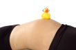30 weeks pregnant teenager with music duck on her belly