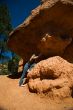 Woman posing under rock