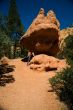 Woman posing under rock