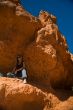 Woman posing under rock