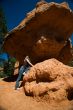 Woman posing under rock