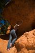 Woman posing under rock