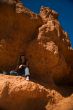 Woman posing under rock