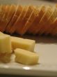 Bread and cheese on a white plate close-up