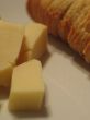 Bread and cheese on a white plate close-up