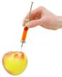 Hand with a syringe and apple