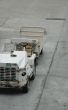 empty airplane gate with small trucks