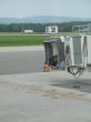 empty airplane gate with small trucks