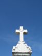 a stone cross and blue clear sky