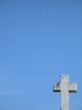 a stone cross and blue clear sky