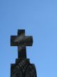 a stone cross and blue clear sky