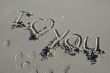 I love you inscription on a sand beach