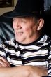 Grandfather with a black cowboy hat posing