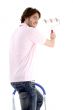 man standing on chair and holding paint roller