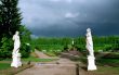 Classical statues in park and rainbow