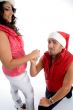 man proposing to the woman with christmas hat