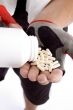 man taking capsules on hand
