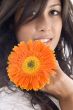 close up of beautiful model with orange gerbera