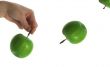 The thrown green tasty-looking apple from hand
