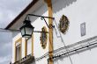 House with yellow decoration, street lamp and Madonna