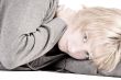 Sad looking beautiful girl lying on the floor looking at you