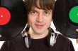 Young man with a headphones and vinylic disc.