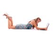 Beautiful woman using laptop, lying on the floor.