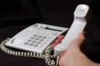 White business telephone on hand