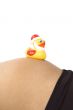 30 weeks pregnant teenager with christmas duck on her belly