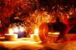 The burning candles, balls and gold ribbons it are Christmas