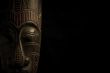 African mask over black background