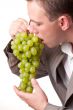 man eats green grapes