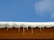 Snow with icicles on the roof