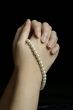 Hands in prayer with pearls