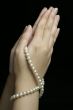 Hands in prayer with pearls