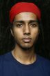 Young indian man with red scarf headwear