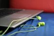 Green earphones and laptop