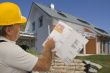 Construction worker with plan of an architect