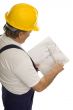 Construction worker with plan of an architect
