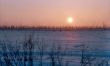 Skiers in winter sunset