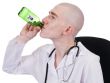 Man in doctor`s smock with green bottle