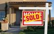 Sold Home For Sale Sign and House