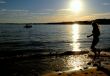 Silhouette woman jumping at the beach