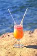 fresh juice orange and papaya on the beach of the sea