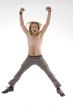 shirtless man jumping high in joy