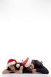two friends lying on the floor with christmas hat