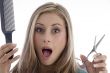 surprised woman holding scissor and comb