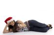young woman in christmas hat lying on floor